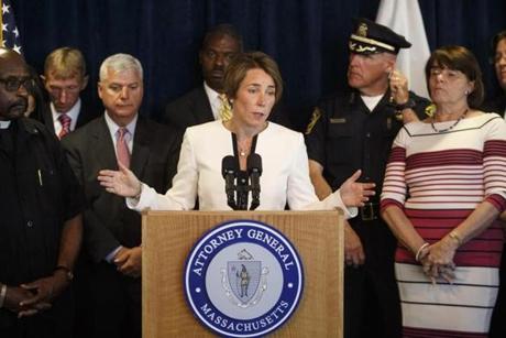 At the announcement of the new rules, Massachusetts Attorney General Maura Healey was surrounded by prosecutors, police chiefs, and relatives of victims of violence who support getting rid of the loophole.
