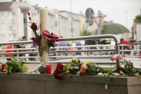MUNICH, GERMANY - JULY 23: Flowers and candles are seen outside the OEZ shopping center the day after a shooting spree left nine victims dead on July 23, 2016 in Munich, Germany. According to police an 18-year-old German man of Iranian descent shot nine people dead and wounded at least 16 before he shot himself in a nearby park. For hours during the spree and the following manhunt the city lay paralyzed as police ordered people to stay off the streets. Original reports of up to three attackers seem to have been unfounded. The shooter's motive is so far unclear. (Photo by Johannes Simon/Getty Images)
