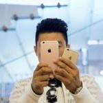 A man took pictures as Apple iPhone 6s and 6s Plus went on sale at an Apple Store in Beijing. 