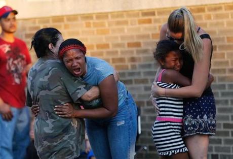 Family and friends of Kyzr Willis comforted one another near a command center. 
