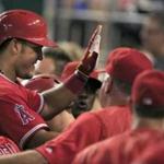 Los Angeles Angels' Carlos Perez is congratulated by teammates following his solo home run during the sixth inning of a baseball game against the Kansas City Royals at Kauffman Stadium in Kansas City, Mo., Tuesday, July 26, 2016. (AP Photo/Orlin Wagner)
