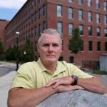 Lowell City Councilor Rodney Elliott in front of the Lofts at Perkins Park, an apartment complex that was recently bought by UMass-Lowell, thereby removing it from city tax rolls