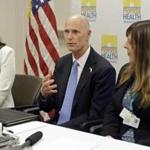 Gov. Rick Scott, center, flanked by Dr. Celeste Philip, State Surgeon General, left, and Dr. Paula Thaqi, Director of the Broward County Health Department, right, talks to community leaders, at the Broward County Health Department, Tuesday, July 26, 2016, in Fort Lauderdale, Fla. Gov. Scott reiterated the importance of Zika preparedness. The tropical mosquito that carries Zika, Aedes aegypti, likes to live near people and it doesn't travel far. Hand-spraying and removing the standing water where they breed, more extensive use of air conditioning and window screens, wider use of bug repellant and broader mosquito control measures will help control the spread of Zika by mosquitoes. (AP Photo/Alan Diaz)