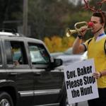 Canton, MA 11/07/2015 â?? Mason Grainger (cq) of Boston, plays his bugle during a protest on Washington Street in Canton, MA on November 07, 2015. Members of Friends of the Blue Hill Deer gathered on the edge of Blue Hill Reservation to protest plans for controlled hunts to cull the reservations deer population. 
