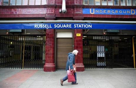 A woman walked past a closed entrance of Russell Square underground station in London. 
