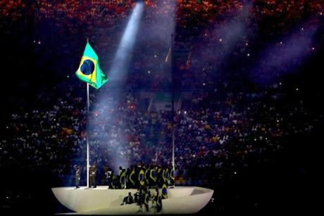 The Brazil flag is raised during a performance at the Opening Ceremony.

