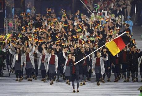 Flagbearer Timo Boll from Germany leads his contingent during the Opening Ceremony.
