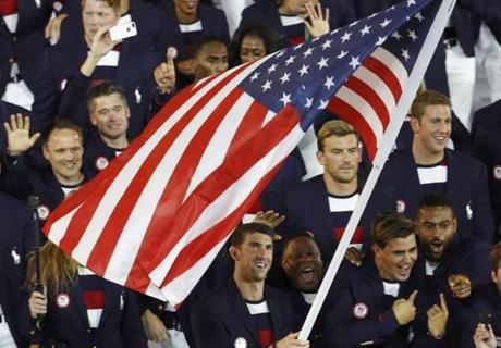 Flagbearer Michael Phelps of the United States leads his contingent during the Opening Ceremony. 
. 
