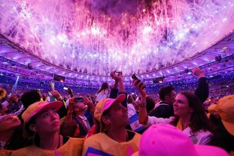 Fireworks illuminate the sky over the Maracana Stadium as athletes take photographs during the Opening Ceremony of the Rio 2016 Olympic Games.
