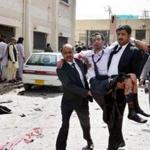 An injured lawyer was carried in Quetta Monday. Dozens of lawyers had gathered at a hospital after the president of the Baluchistan Bar Association was slain.