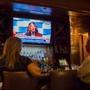 Patrons view the Democratic National Convention on a TV at the bar inside the Franklin Hotel in Philadelphia on July 26.
