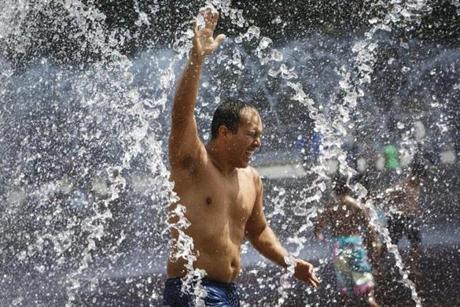 Boston, MA - 8/14/2016 - Andres Berrio runs through the fountain at the Christian Science Center to stay cool in Boston, MA, August 14, 2016. (Keith Bedford/Globe Staff) 
