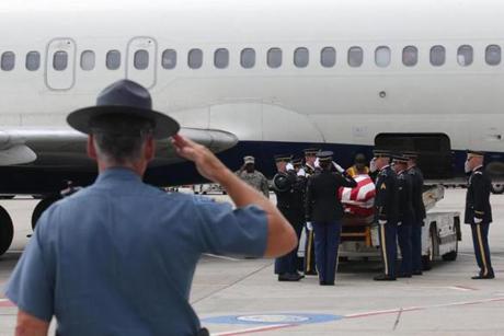 A state trooper saluted as the body of Korean War prisoner of war Ronald M. Sparks was unloaded from a plane at Logan International Airport on Tuesday.

