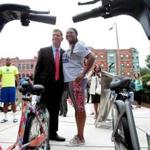 Mayor Martin Walsh and Michelle Cook, founder of Roxbury Rides, celebrated the new Hubway station outside the Roxbury YMCA.