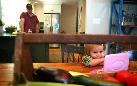Nina Bagby, 1, who had an elevated lead level, hangs out in the kitchen of her family?s home with her dad close by. 
