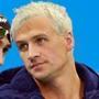 Ryan Lochte and three of his teammates say they were robbed at gunpoint in a taxi late Sunday morning as they returned to the athletes village from a party.