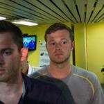 American Olympic swimmers Gunnar Bentz, left, and Jack Conger, center, leave the police station at Rio International airport early Thursday Aug. 18, 2016. The two were taken off their flight from Brazil to the U.S. on Wednesday by local authorities amid an investigation into a reported robbery targeting Ryan Lochte and his teammates. According to their lawyer they will not be allowed to leave Brazil until they provide testimony about the robbery. (AP Photo/Mauro Pimentel)