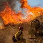 Firefighters battle da wildfire on Cajon Boulevard in Keenbrook, Calif., on Wednesday.