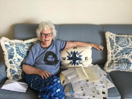 Doris Buffett, in her Back Bay home, with letters she has gotten from people looking to read the aid requests she and her brother, Warren, get and evaluate their merit.
