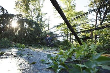 8/22/16 - Concord, MA - Crews from the Concord Light Department were out since the pre-dawn hours cleaning up downed trees and fallen power lines on Hawthorne Lane and Lexington Road in Concord, MA on Monday morning, August, 22, 2016. Severe weather moved through eastern Massachusetts in the early hours Monday, leaving damage in its wake. Photo by Dina Rudick/Globe Staff8/22/16 - Concord, MA - Crews from the Concord Light Department were out since the pre-dawn hours cleaning up downed trees and fallen power lines on Hawthorne Lane and Lexington Road in Concord, MA on Monday morning, August, 22, 2016. Severe weather moved through eastern Massachusetts in the early hours Monday, leaving damage in its wake. Topic: 23storm. Photo by Dina Rudick/Globe Staff
