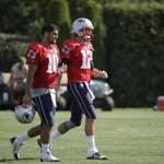 New England Patriots quarterbacks Jimmy Garoppolo, left, and Tom Brady, right, walk on the field following an NFL football training camp practice with the Chicago Bears Monday, Aug. 15, 2016, in Foxborough, Mass. (AP Photo/Steven Senne)