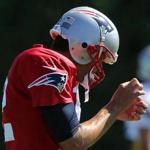 Tom Brady checked out his injured thumb at practice Tuesday.