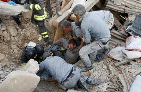 A man is rescued alive from the ruins following an earthquake in Amatrice, central Italy, August 24, 2016. REUTERS/Remo Casilli TPX IMAGES OF THE DAY 
