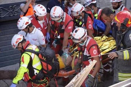 Emergency services personnel carried a survivor on a stretcher during search and rescue operations in Amatrice, Italy. 
