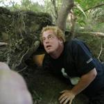 Dominic Kane stuck his arm into a hole as he searched for Wessie the missing python.