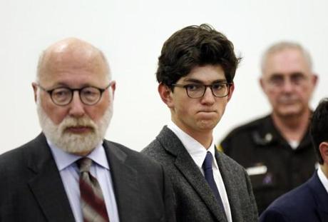 Owen Labrie, center, listens to prosecutors with his lawyer J.W. Carney, left, before being sentenced in Merrimack County Superior Court, Thursday Oct. 29, 2015 in Concord, N.H. The graduate of the exclusive St. Paul?s School was sentenced to a year in jail for sexually assaulting a 15-year-old freshman girl as part of a tradition in which upperclassmen competed to rack up sexual conquests. Labrie was allowed to remain free on bail while he appeals his conviction. (AP Photo/Jim Cole, Pool)
