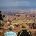 In this Wednesday, Aug. 24, 2016 photo, visitors look at Grand View Point in the Island in the Sky District at Canyonlands National Park near Moab, Utah. The National Park Service marks its 100th anniversary on Thursday, Aug. 25, 2016. (Chris Detrick/The Salt Lake Tribune via AP)
