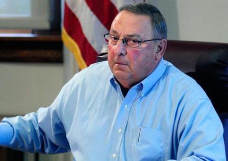 Governor Paul LePage of Maine held up a news release with a booking mug shot from a three-ring binder of news releases and articles about drug arrests.
