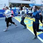 Runners crossed the Boston Marathon Finish Line during the 2016 B.A.A. 5k on April 16, 2016. 