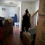 FOR DAVID SCHARFENBERG HOUSING STORY PLEASE DO NOT PUBLISH PRIOR 06/18/2016 -Boston, MA- Shantel Young (cq) looks over the living room of her new home in the Dorchester neighborhood of Boston, MA on June 18, 2016. She and her husband Rob and their two children moved from a two bedroom apartment to a three bedroom home just over a mile apart in Dorchester. Shantel said she is looking forward to having more room, 