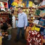 Adam Hirsch at the Curious George Store, the 21-year-old Harvard Square shop that he and his wife have owned for the past four years.