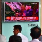 People watch a television news report, showing file footage of North Korean leader Kim Jong-Un, at a railway station in Seoul on September 9, 2016. North Korea claimed September 9 it has successfully tested a nuclear warhead that could be mounted on a missile, drawing condemnation from the South over the 