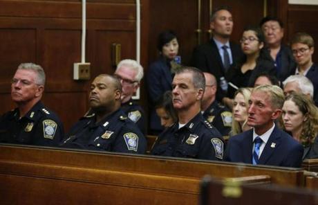 Boston, MA - 9/6/2016 - Members of the Boston Police Department including Police Commissioner William Evans (R) and Superintendent-in-Chief William Gross (2nd from L) listen to the proceedings during the body camera hearing at Suffolk Superior Court in Boston, MA, September 6, 2016. (Jessica Rinaldi/Globe Staff) Topic: 07camerapic 

