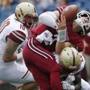 Massachusetts quarterback Ross Comis (2) fumbles the ball as he is hit by Boston College defensive back Isaac Yiadom, bottom right, during the second quarter of an NCAA college football game in Foxborough, Mass., Saturday, Sept.10, 2016. (AP Photo/Michael Dwyer)