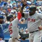 Sep 11, 2016; Toronto, Ontario, CAN; Boston Red Sox designated hitter David Ortiz (34) bumps forearms with second baseman Dustin Pedroia (15) after hitting a three run home run as Toronto Blue Jays catcher Russell Martin (55) looks on in the sixth inning at Rogers Centre. Mandatory Credit: Dan Hamilton-USA TO DAY Sports