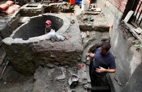 Archaeologist Elizabeth Neill (left) worked in the cistern while city archaeologist Joe Bagley worked in the privy.
