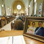 A photograph of Sister Margaret Held and Sister Paula Merrill was placed at the entrance of a Mississippi cathedral during an Aug. 29 memorial Mass.