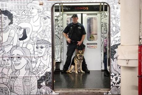 A member of the NYPD K-9 Unit patrolLED on a subway train between Grand Central Terminal and Times Square on Sunday. 
