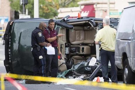 Boston Police investigate a rolled over vehicle on Warren St. in Roxbury on Wednesday, Sept. 21, 2016. (Scott Eisen for The Boston Globe)
