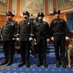 Medal of Valor winners (left to right) Trooper Nathan R. Monteiro, Bourne Detective Sergeant John R. Stowe Jr., Sergeant Wallace J. Perry IV, and Officer Joshua A. Parsons were joined by Bourne officer Jared P. MacDonald and his service dog, Bullet. MacDonald was shot in the line of duty and is retiring. 