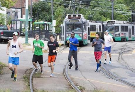 A group of runners began their race against an MBTA Green line train along Commonwealth Avenue in Boston.
