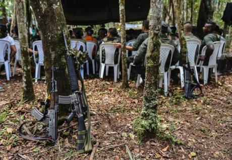Members of the Revolutionary Armed Forces of Colombia (FARC) attend a meeting at the camp in Llanos del Yari, Caqueta Department, Colombia, on September 16, 2016 ahead of the 10th National Guerrilla Conference to be held from September 17 through 23. After 52 years of conflict, FARC rebels open what leaders hope will be their last conference as a guerrilla army, where they are due to vote on a historic peace deal with the Colombian government. / AFP PHOTO / LUIS ACOSTALUIS ACOSTA/AFP/Getty Images
