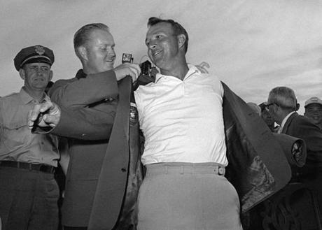 Arnold Palmer slipped into his green jacket with help from Jack Nicklaus after winning the 1964 Masters. 
