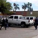 A video still frame provided by the El Cajon Police Department, a man, second from left, faced police officers in El Cajon, Calif. The man reportedly acting erratically at a strip mall in suburban San Diego was shot and killed by police.