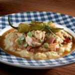 Lowcountry shrimp and grits with andouille sausage, bell pepper, and tasso ham gravy at Southern Kin Cookhouse.