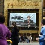 FILE - In this Saturday, March 27, 2004 file photo, passersby look at a sign advertising the reality television show, 